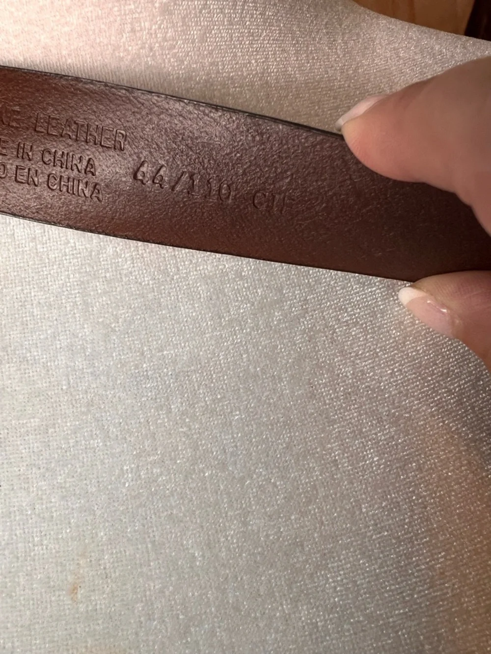 Izod Unique vintage genuine leather belt features a classic brown leather strap
